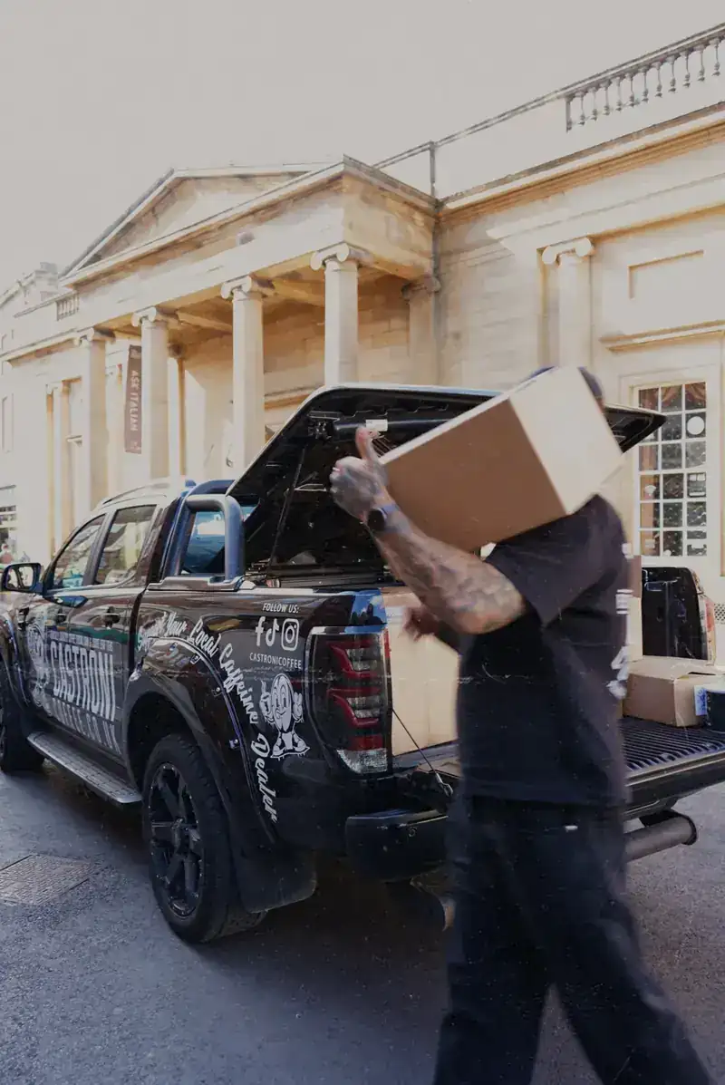 Carrying a box of coffee into a customer's café