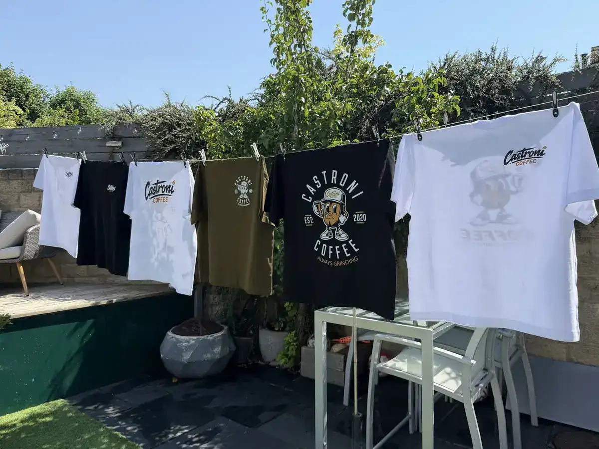 Castroni Coffee tees hanging at a market stall